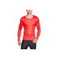 holding a red long sleeved compression shirt